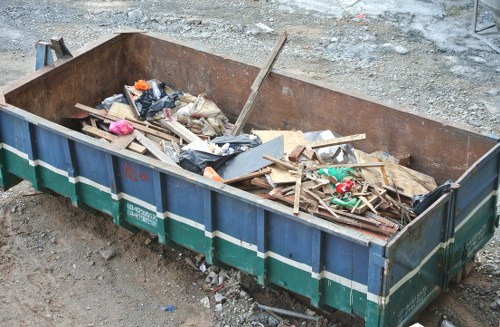 Construction site with builders waste being cleared in Knightsbridge